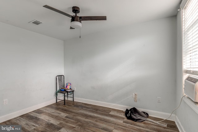 unfurnished room with ceiling fan and dark hardwood / wood-style flooring