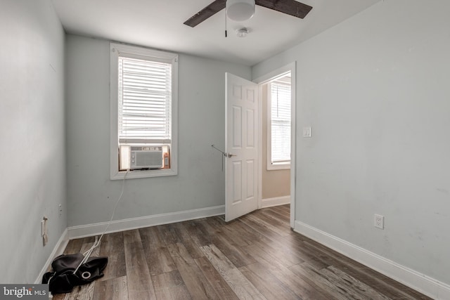 unfurnished room featuring ceiling fan, cooling unit, and dark hardwood / wood-style flooring