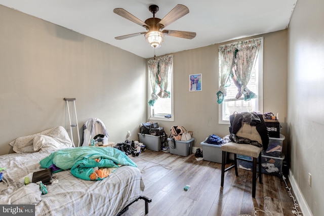 bedroom with ceiling fan and wood-type flooring