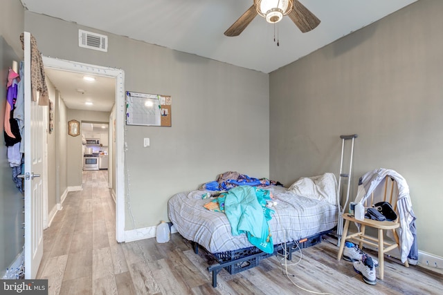 bedroom with ceiling fan and hardwood / wood-style floors