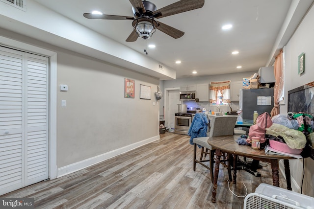 dining space featuring light hardwood / wood-style flooring and ceiling fan