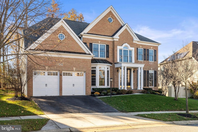 view of front of house featuring a front lawn and a garage