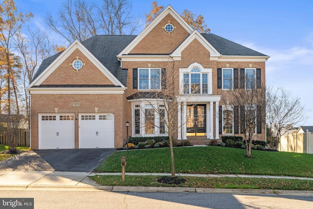 view of front of house with a garage and a front lawn