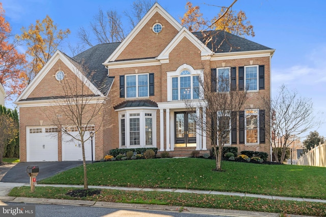 view of front facade featuring a front lawn and a garage