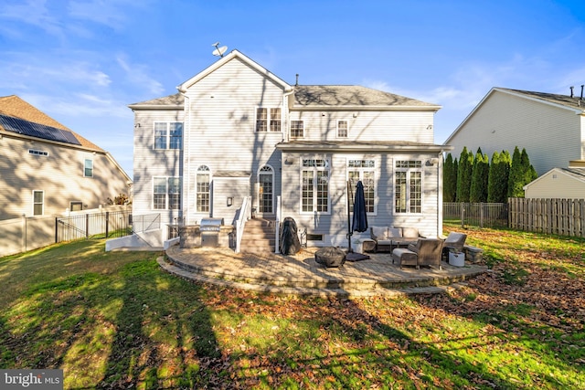 back of house featuring an outdoor hangout area, a patio area, and a yard