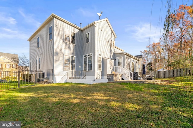 back of property featuring a yard