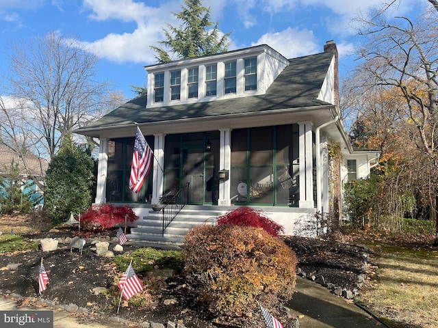 view of front of house with a sunroom