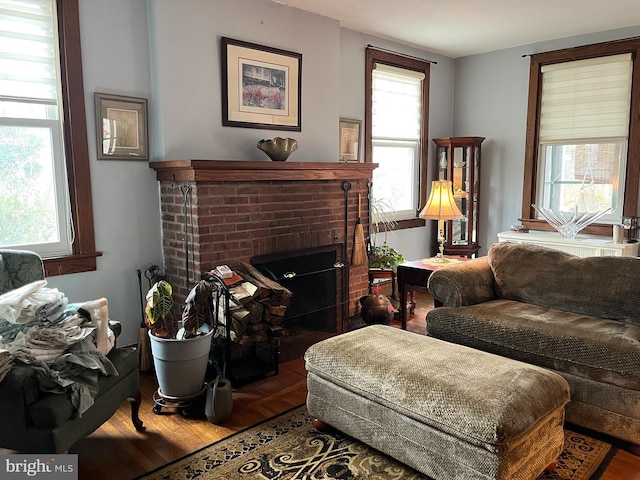 living room featuring hardwood / wood-style floors and a brick fireplace