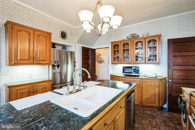 kitchen with an inviting chandelier, sink, ornamental molding, appliances with stainless steel finishes, and decorative light fixtures