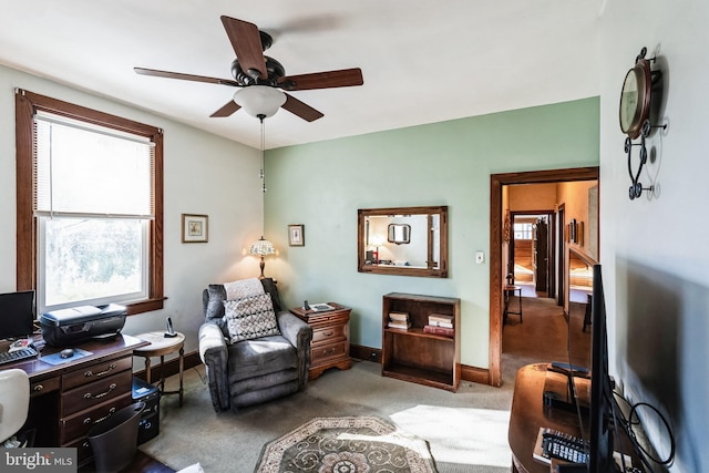 carpeted office featuring ceiling fan