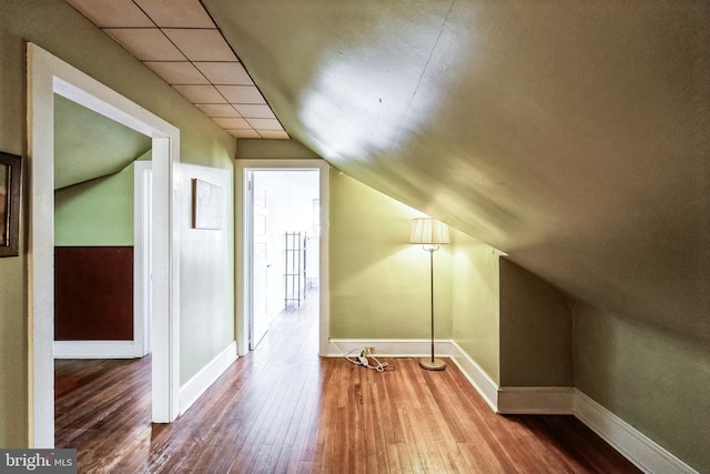 bonus room with hardwood / wood-style flooring and lofted ceiling