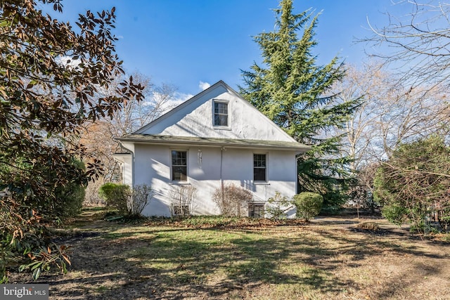 view of property exterior with a yard