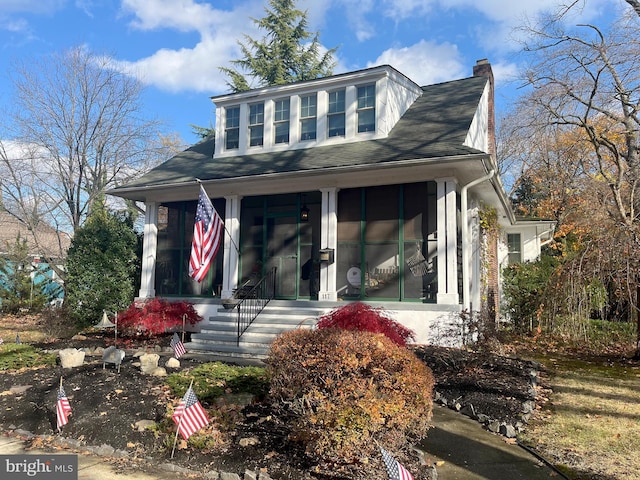 view of front facade with a sunroom