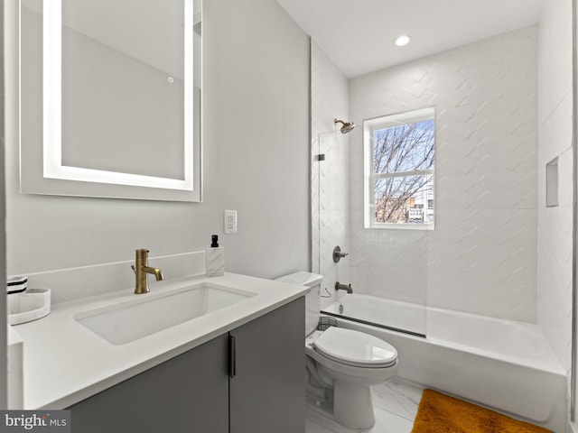 full bathroom featuring vanity, toilet, and tiled shower / bath