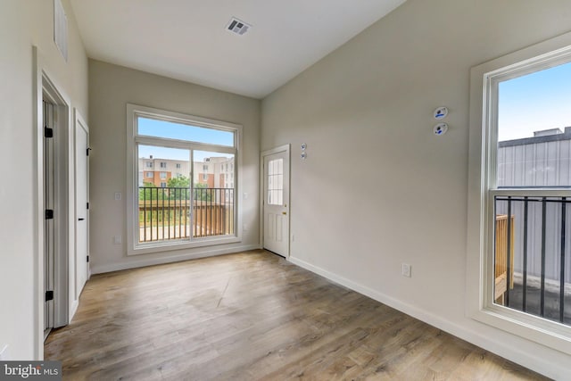 interior space with light hardwood / wood-style flooring and a wealth of natural light