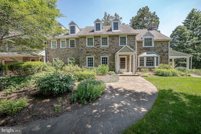 view of front of property featuring a front yard and stone siding