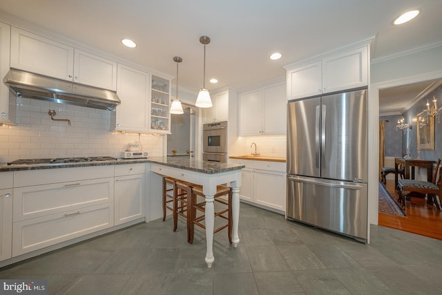 kitchen featuring white cabinets, glass insert cabinets, hanging light fixtures, stainless steel appliances, and under cabinet range hood