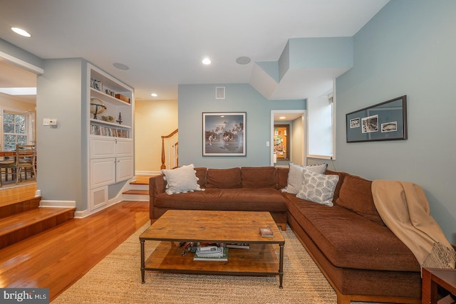 living room featuring recessed lighting, visible vents, stairway, light wood-style flooring, and baseboards