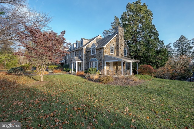 view of property exterior with stone siding, a chimney, and a lawn