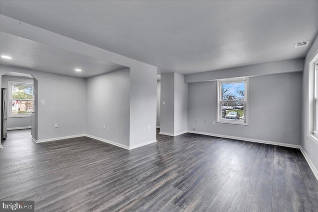 empty room with dark wood-type flooring