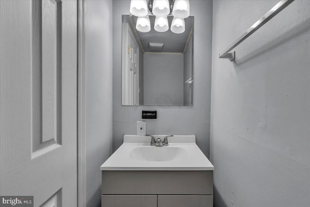 bathroom with vanity and a notable chandelier