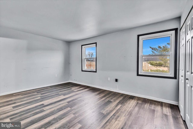 empty room with dark wood-type flooring