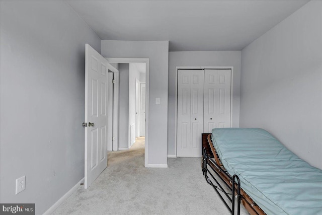 bedroom with light carpet and a closet