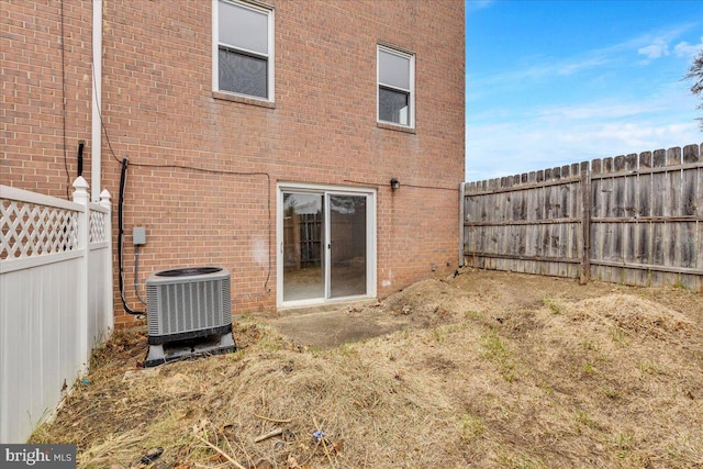 back of house with central air condition unit