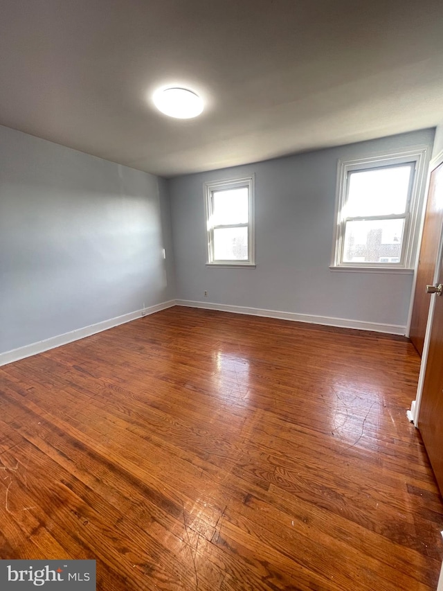 empty room with dark hardwood / wood-style floors