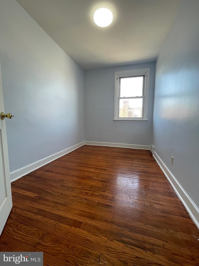 empty room featuring dark wood-type flooring