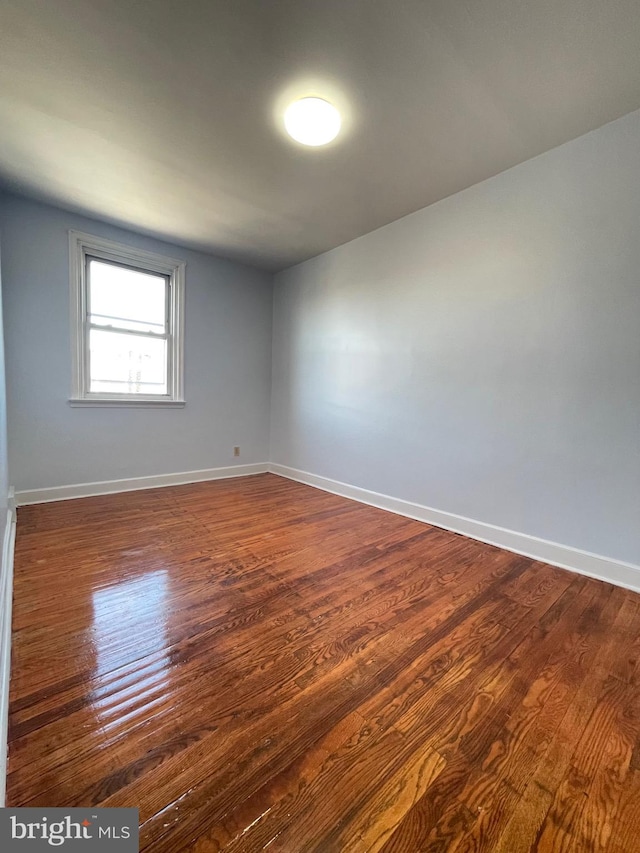 empty room with dark wood-type flooring