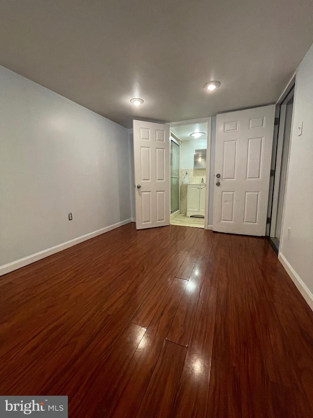 empty room with dark wood-type flooring