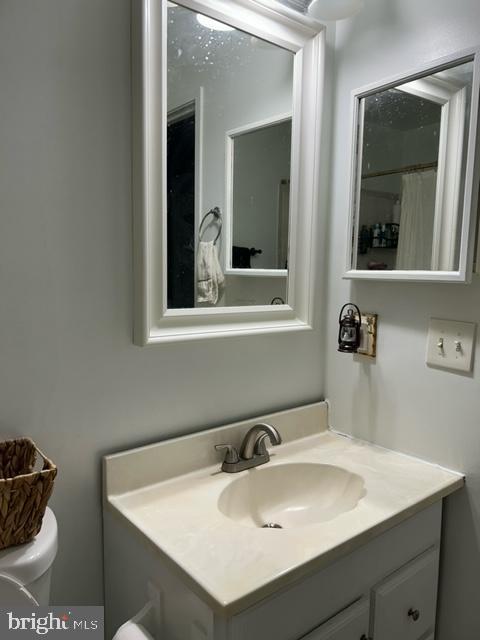 bathroom featuring vanity and toilet