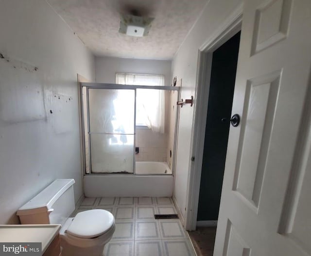 full bathroom featuring vanity, enclosed tub / shower combo, and toilet