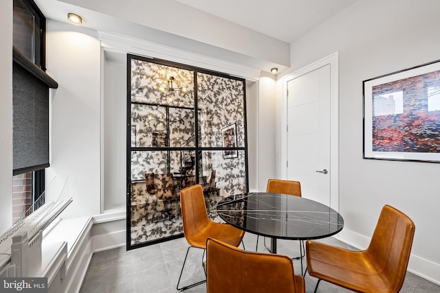 dining room featuring baseboards and tile patterned floors