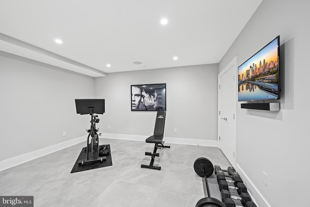 exercise area featuring baseboards and recessed lighting