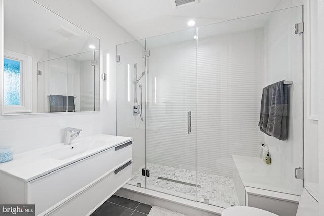 bathroom featuring vanity, a shower stall, and tile patterned floors