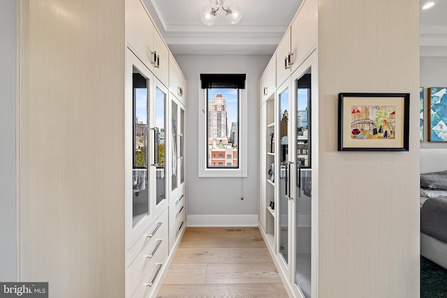 entryway with french doors, light wood-type flooring, visible vents, and baseboards