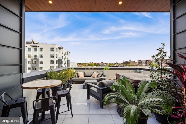 balcony featuring a city view and an outdoor living space