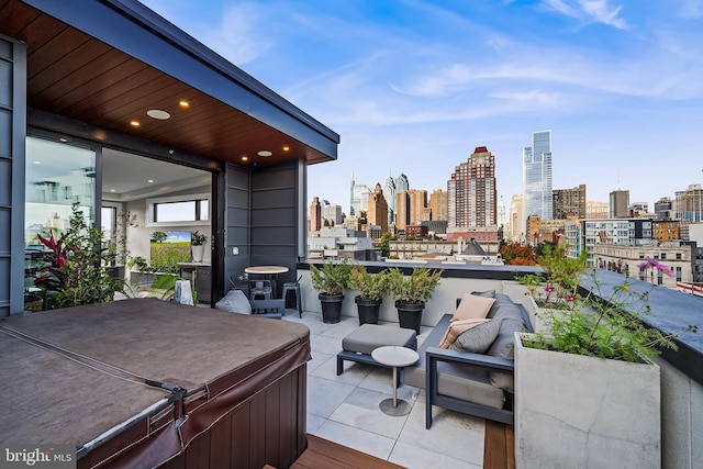 deck featuring a hot tub and a city view