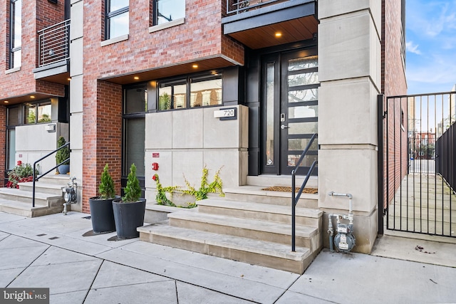 property entrance featuring brick siding