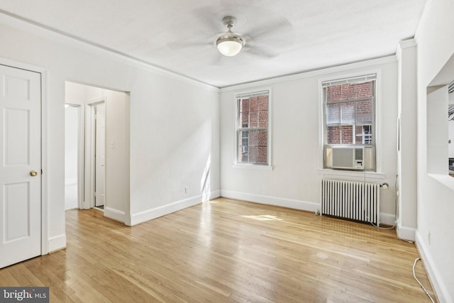 unfurnished room featuring radiator, cooling unit, crown molding, ceiling fan, and light hardwood / wood-style floors