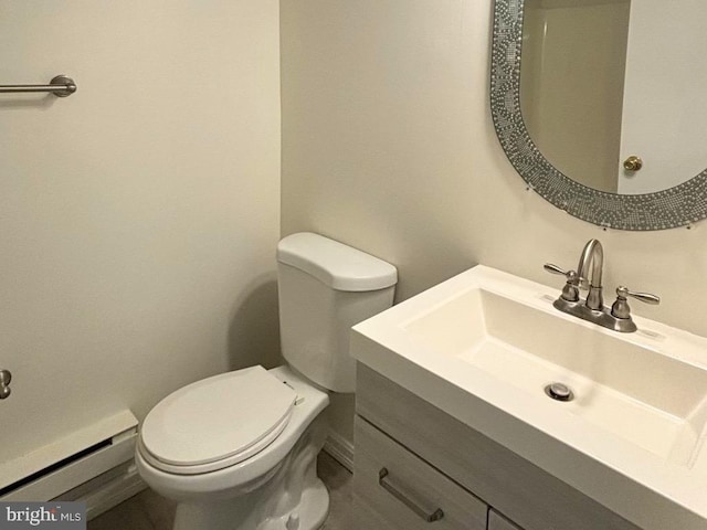 bathroom with vanity, toilet, and a baseboard radiator