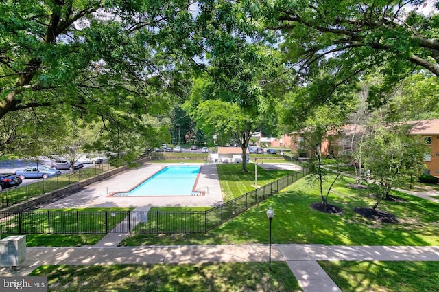 view of pool with a lawn