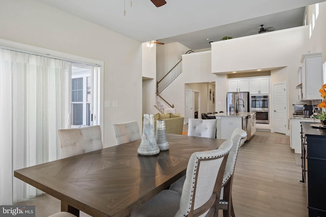 dining area featuring ceiling fan and light hardwood / wood-style flooring