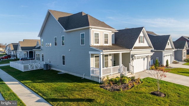 view of front of home with a front lawn, a porch, a garage, and central AC