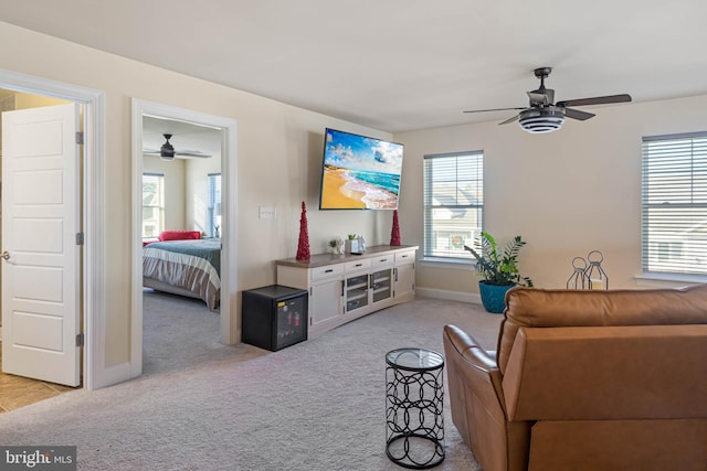 carpeted living room featuring ceiling fan