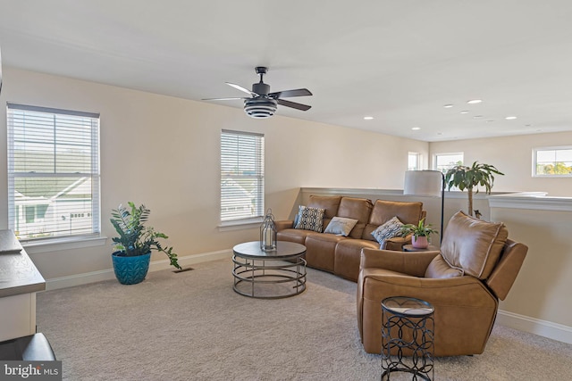 carpeted living room featuring ceiling fan and a healthy amount of sunlight