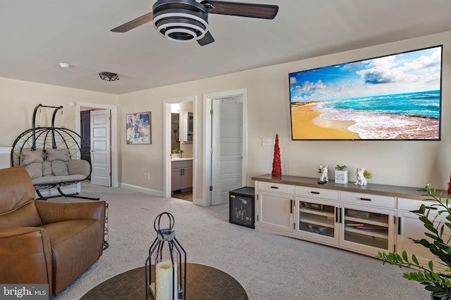 living room with light colored carpet and ceiling fan