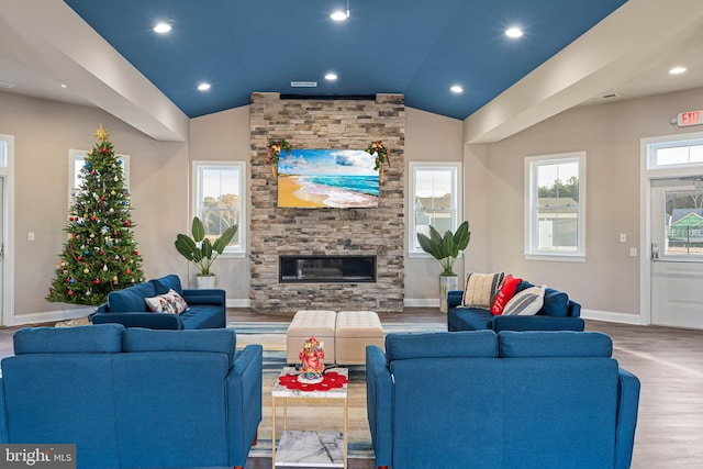 living room featuring a fireplace, hardwood / wood-style floors, and vaulted ceiling